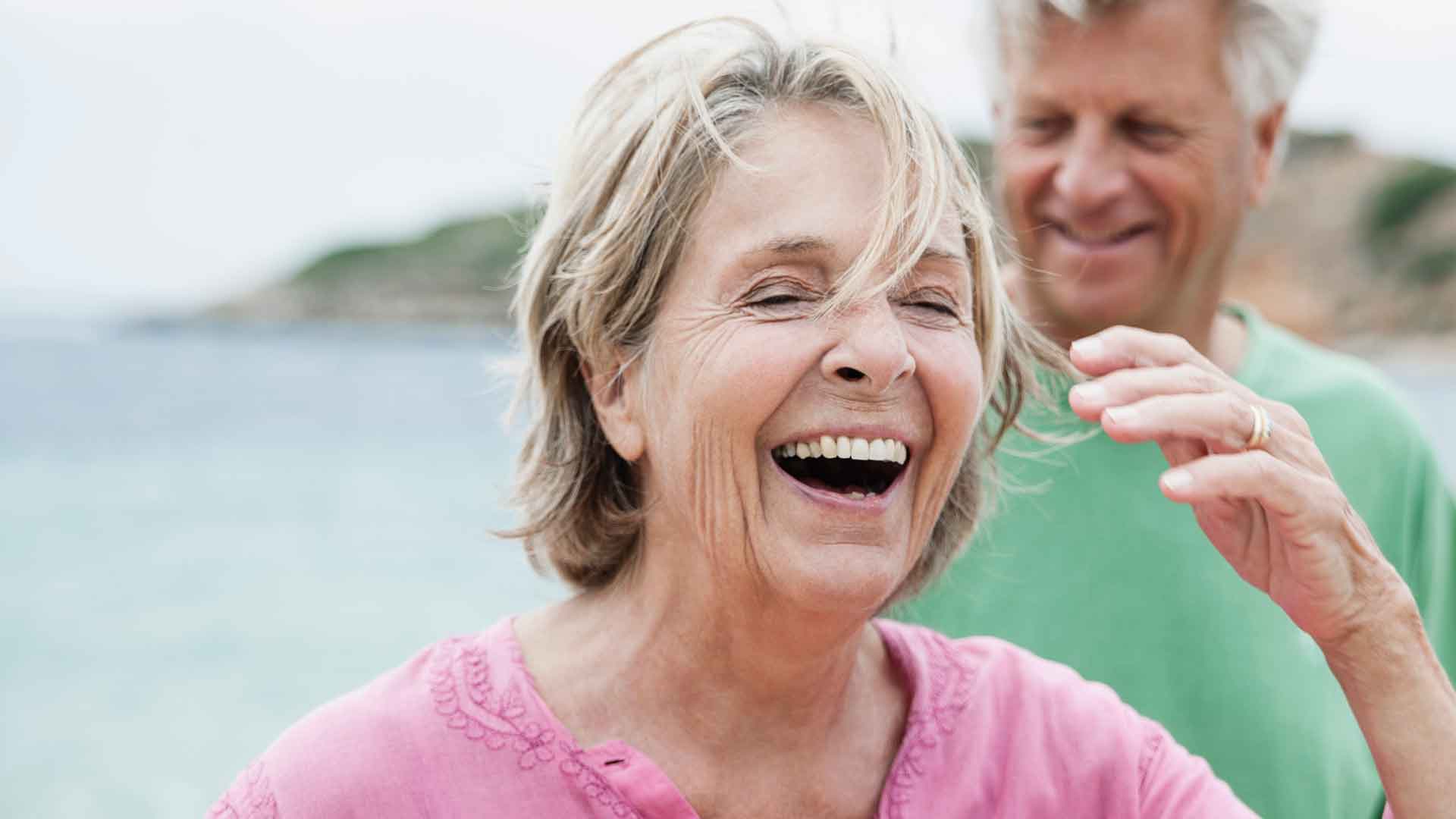 Senior couple laughing.
