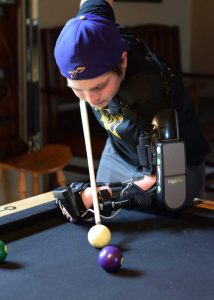 MyoPro user Zeek playing pool.