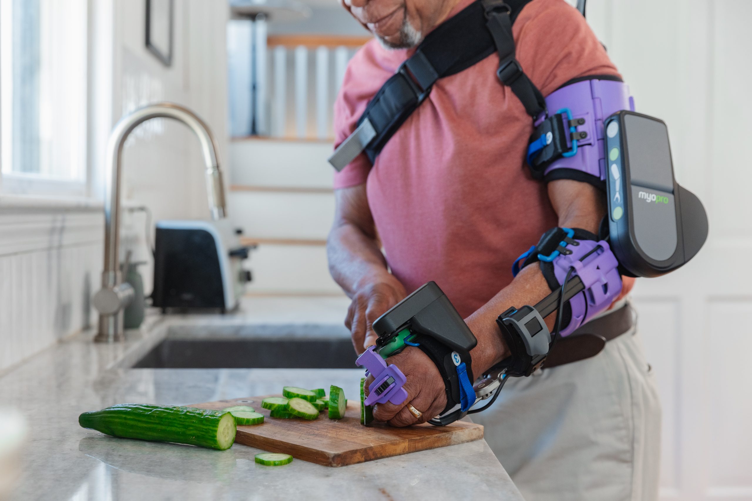 Person using a MyoPro powered orthosis