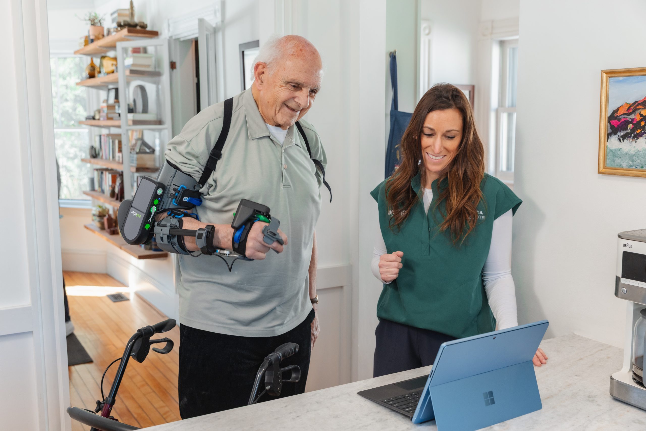 Therapist working with a man wearing a MyoPro&reg;